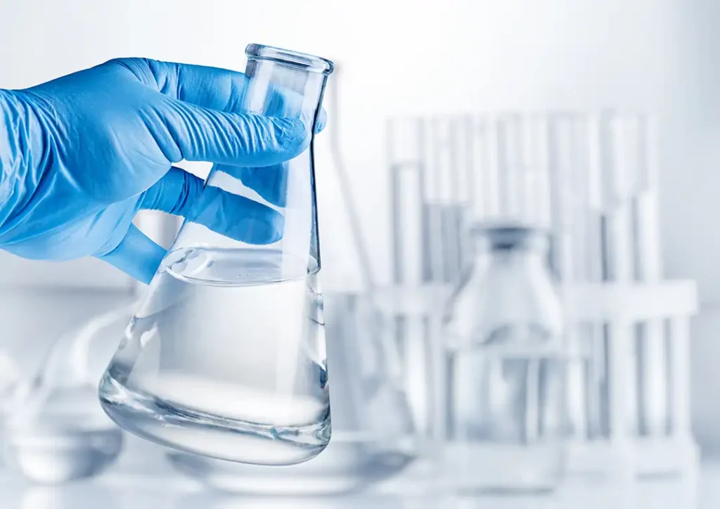 laboratory flask filled with clear denatured alcohol in a laboratory setting
