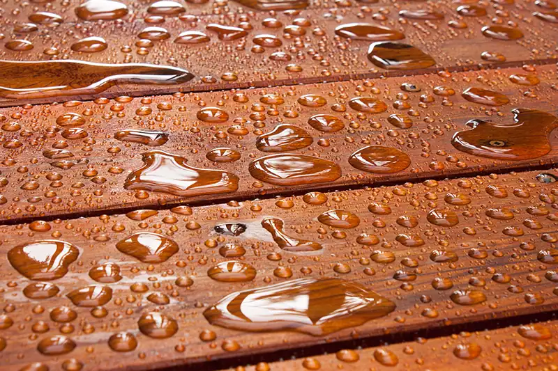 Water droplets on an impregnated wooden surface made water-repellent.