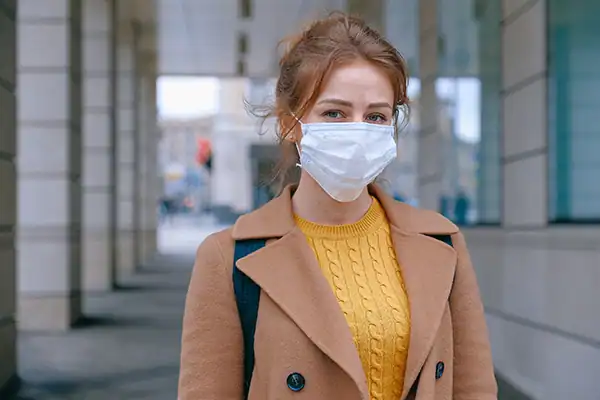 Person wearing a dust mask for optimal respiratory protection.